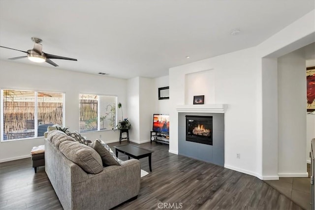 living room with dark hardwood / wood-style floors and ceiling fan