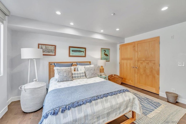 bedroom featuring wood-type flooring and a closet