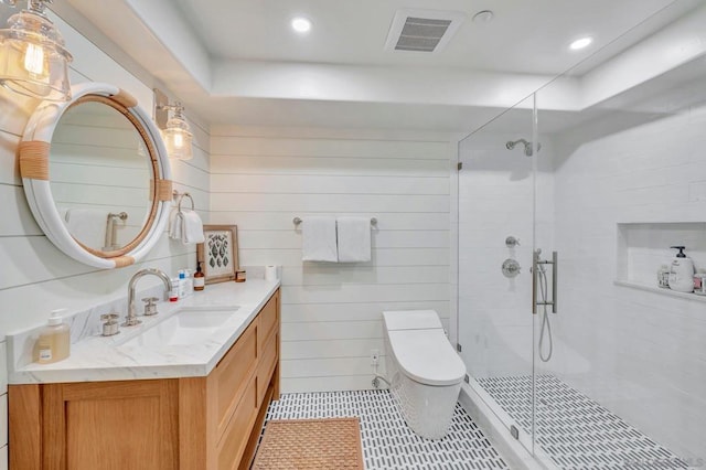 bathroom featuring tile patterned flooring, wood walls, an enclosed shower, toilet, and vanity