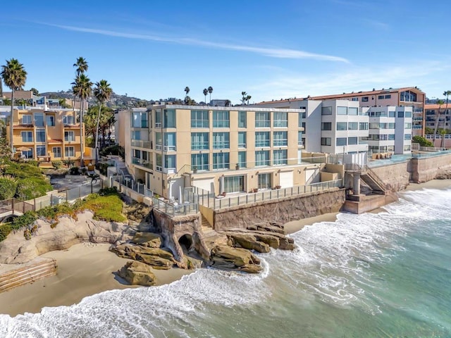 view of community with a view of the beach and a water view