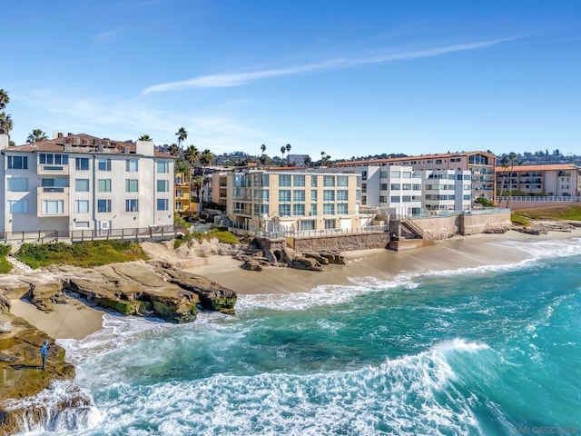 exterior space with a water view and a view of the beach