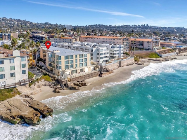 bird's eye view featuring a view of the beach and a water view