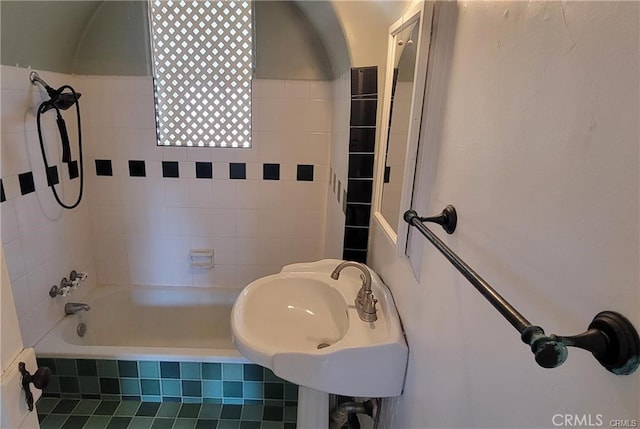 bathroom with tile patterned floors, sink, and tiled shower / bath