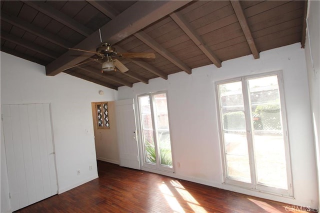 spare room featuring vaulted ceiling with beams, plenty of natural light, dark hardwood / wood-style floors, and ceiling fan