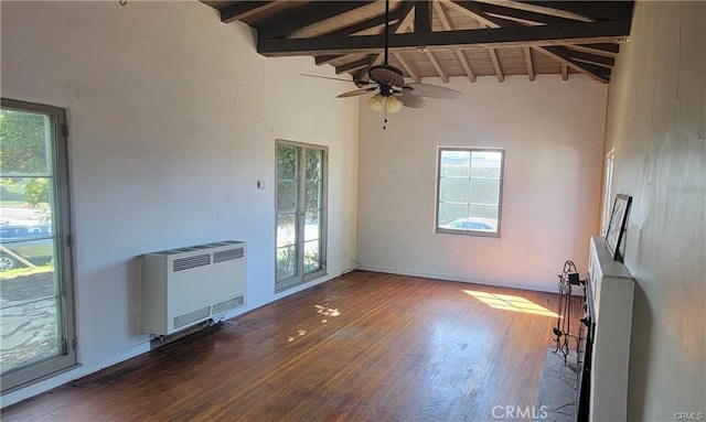 unfurnished living room with heating unit, ceiling fan, beam ceiling, high vaulted ceiling, and dark hardwood / wood-style floors