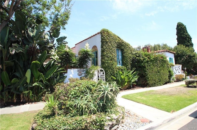 view of property exterior with a lawn