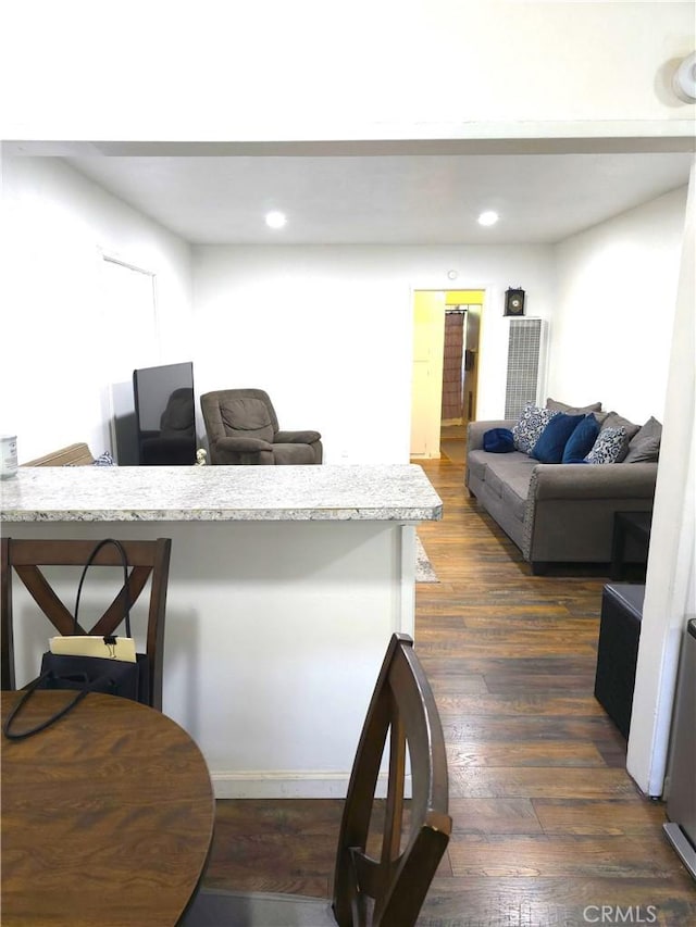 dining space featuring dark wood-type flooring