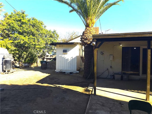 exterior space with a storage unit and a patio