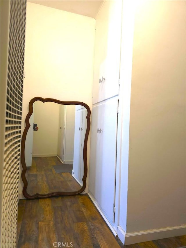 corridor with dark hardwood / wood-style floors