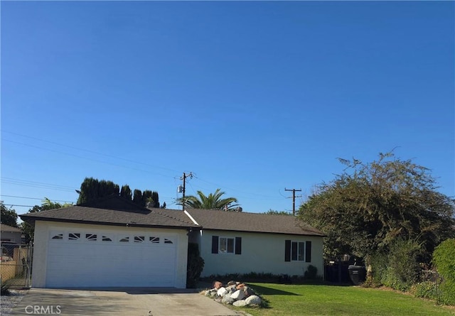 ranch-style house featuring a front yard and a garage