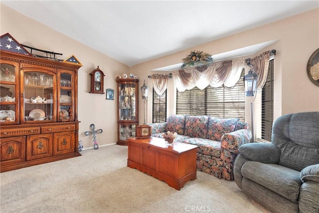 living room with light carpet and vaulted ceiling