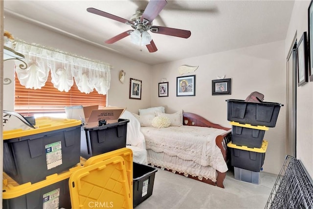 bedroom featuring ceiling fan and light carpet