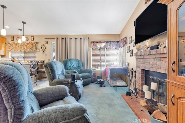 carpeted living room featuring lofted ceiling and a fireplace