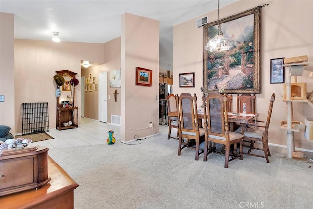 dining space featuring light carpet