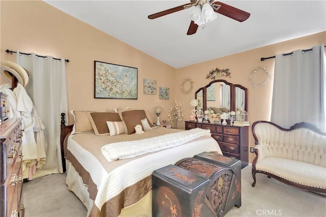 carpeted bedroom with ceiling fan and vaulted ceiling