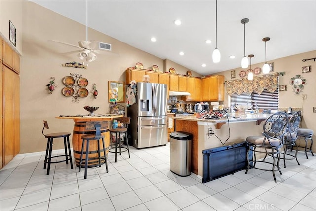 kitchen with ceiling fan, light brown cabinets, hanging light fixtures, stainless steel refrigerator with ice dispenser, and light tile patterned flooring