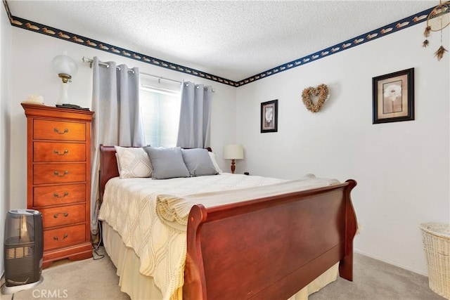 bedroom with a textured ceiling and light colored carpet