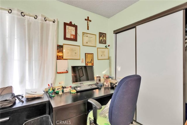 home office featuring a textured ceiling