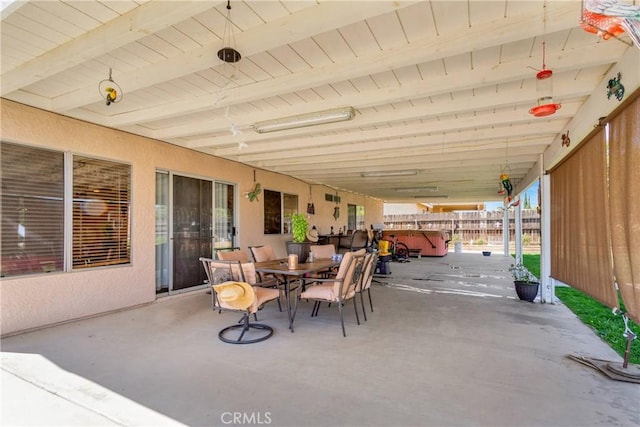 view of patio / terrace with a hot tub