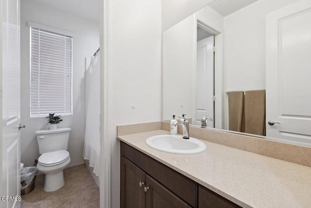 bathroom featuring tile patterned floors, vanity, and toilet