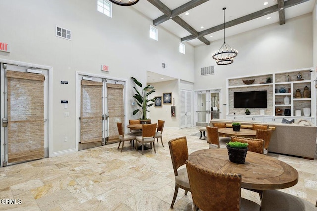 dining room with beam ceiling, a towering ceiling, an inviting chandelier, and french doors