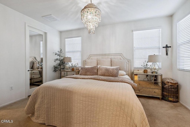 carpeted bedroom with an inviting chandelier and multiple windows