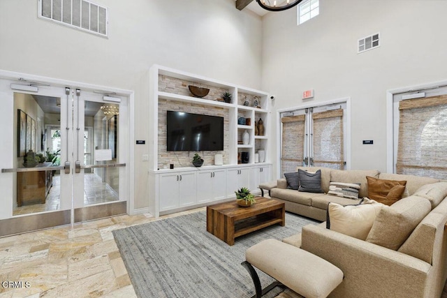 living room with french doors and a high ceiling