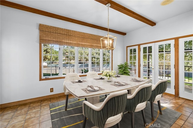 tiled dining space featuring beam ceiling, french doors, and a chandelier