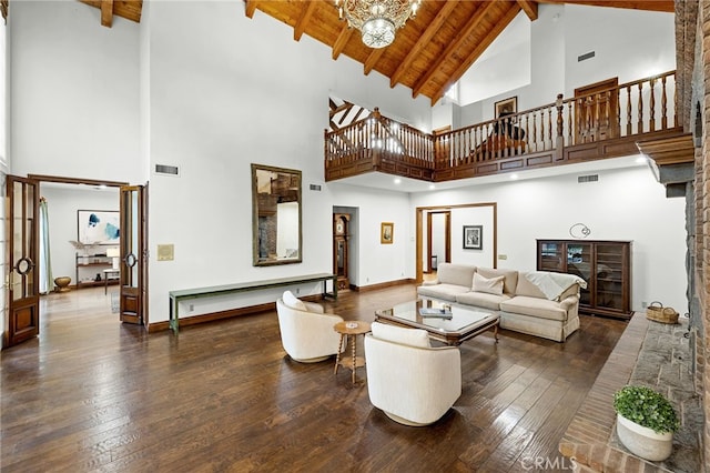 living room featuring a notable chandelier, beamed ceiling, dark hardwood / wood-style floors, and high vaulted ceiling