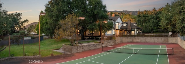 view of tennis court featuring a mountain view and basketball court