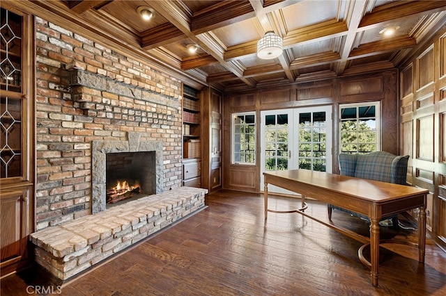 office area with wooden walls, a brick fireplace, wooden ceiling, crown molding, and coffered ceiling