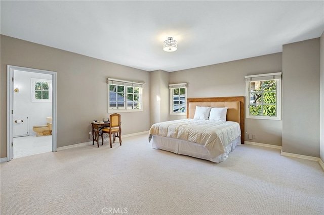 carpeted bedroom featuring ensuite bathroom