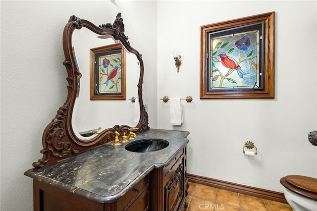 bathroom featuring tile patterned floors, vanity, and toilet