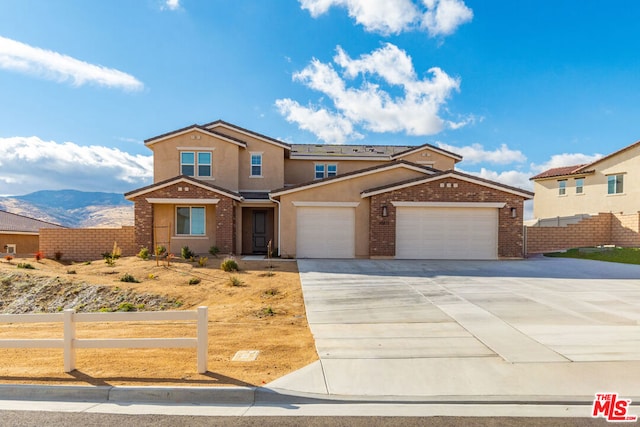 view of front of home featuring a mountain view and a garage