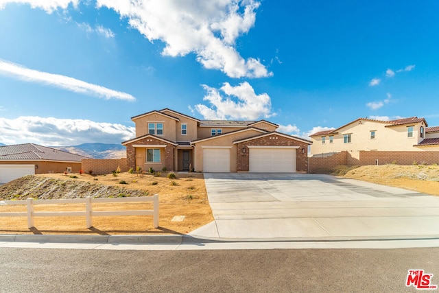 view of front of home featuring a mountain view and a garage