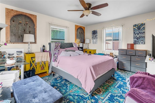 bedroom with ceiling fan and dark wood-type flooring