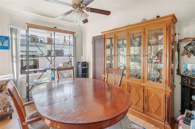 dining room with ceiling fan and light hardwood / wood-style floors