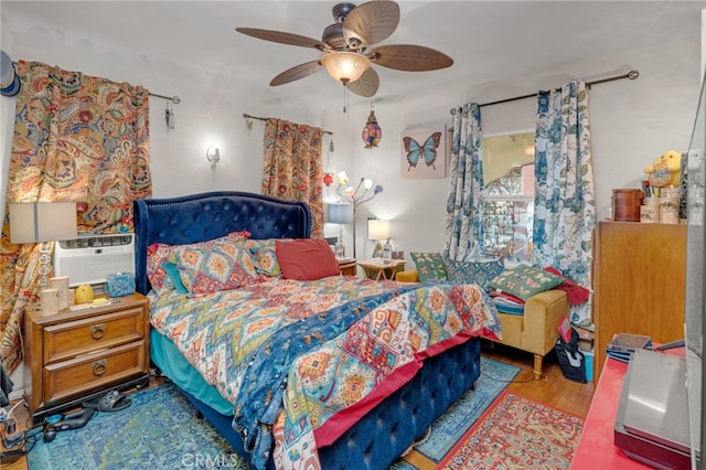 bedroom with ceiling fan, cooling unit, and light wood-type flooring