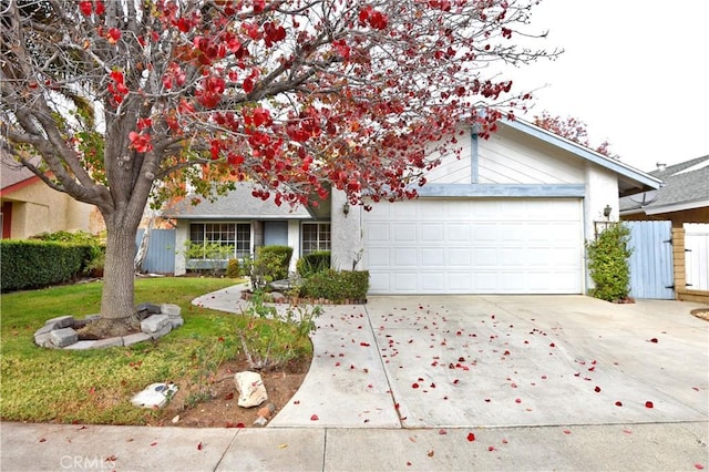 single story home featuring a garage and a front yard