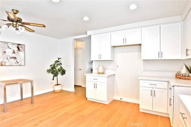 kitchen with white cabinets and light wood-type flooring