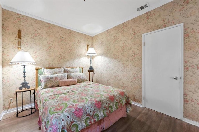 bedroom with wood-type flooring and crown molding