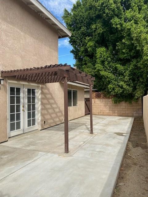 view of patio / terrace featuring french doors and a pergola