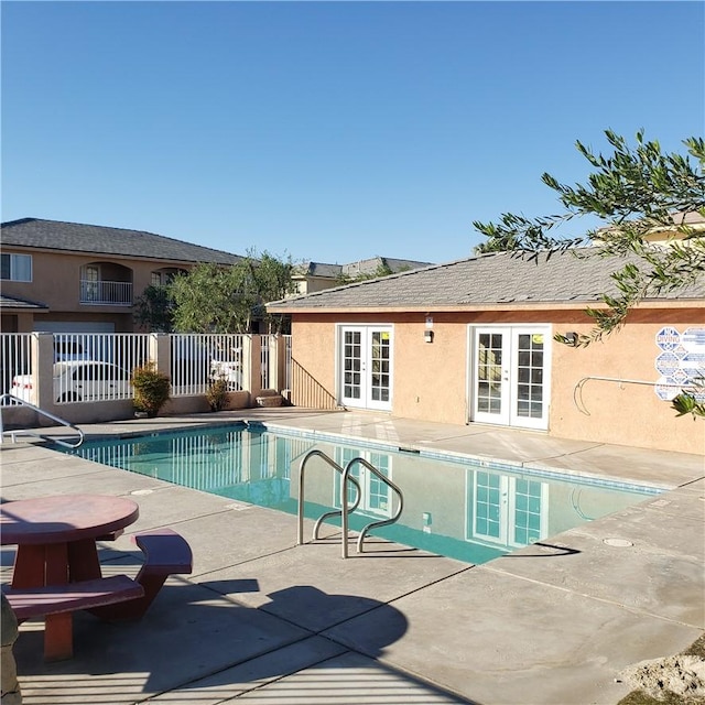 view of swimming pool with a patio area and french doors