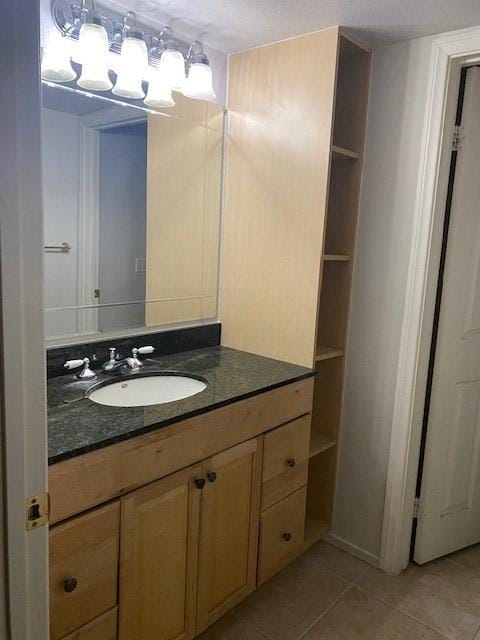 bathroom with tile patterned floors and vanity