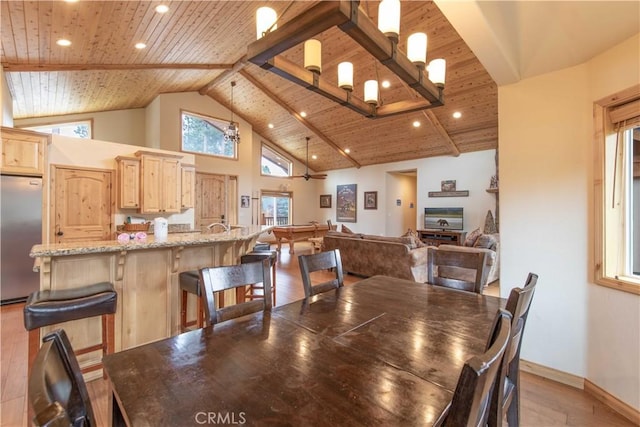 dining space with baseboards, wood ceiling, light wood-style flooring, beamed ceiling, and high vaulted ceiling