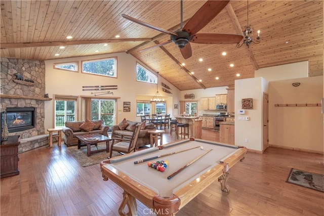 game room with light hardwood / wood-style flooring, high vaulted ceiling, a stone fireplace, and wood ceiling