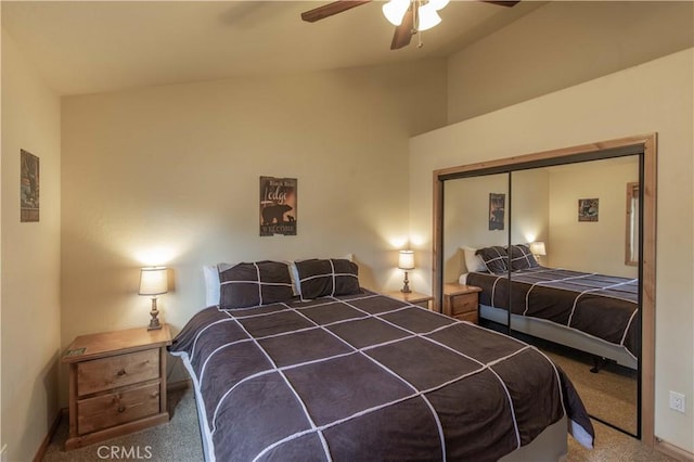 carpeted bedroom with baseboards, a ceiling fan, vaulted ceiling, and a closet