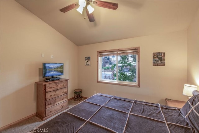 carpeted bedroom featuring a ceiling fan, vaulted ceiling, and baseboards