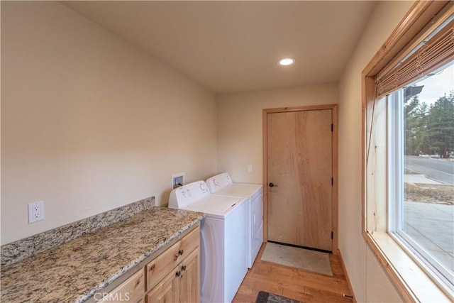 laundry room with recessed lighting, cabinet space, washing machine and clothes dryer, and light wood finished floors