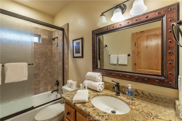 full bathroom with toilet, vanity, and combined bath / shower with glass door